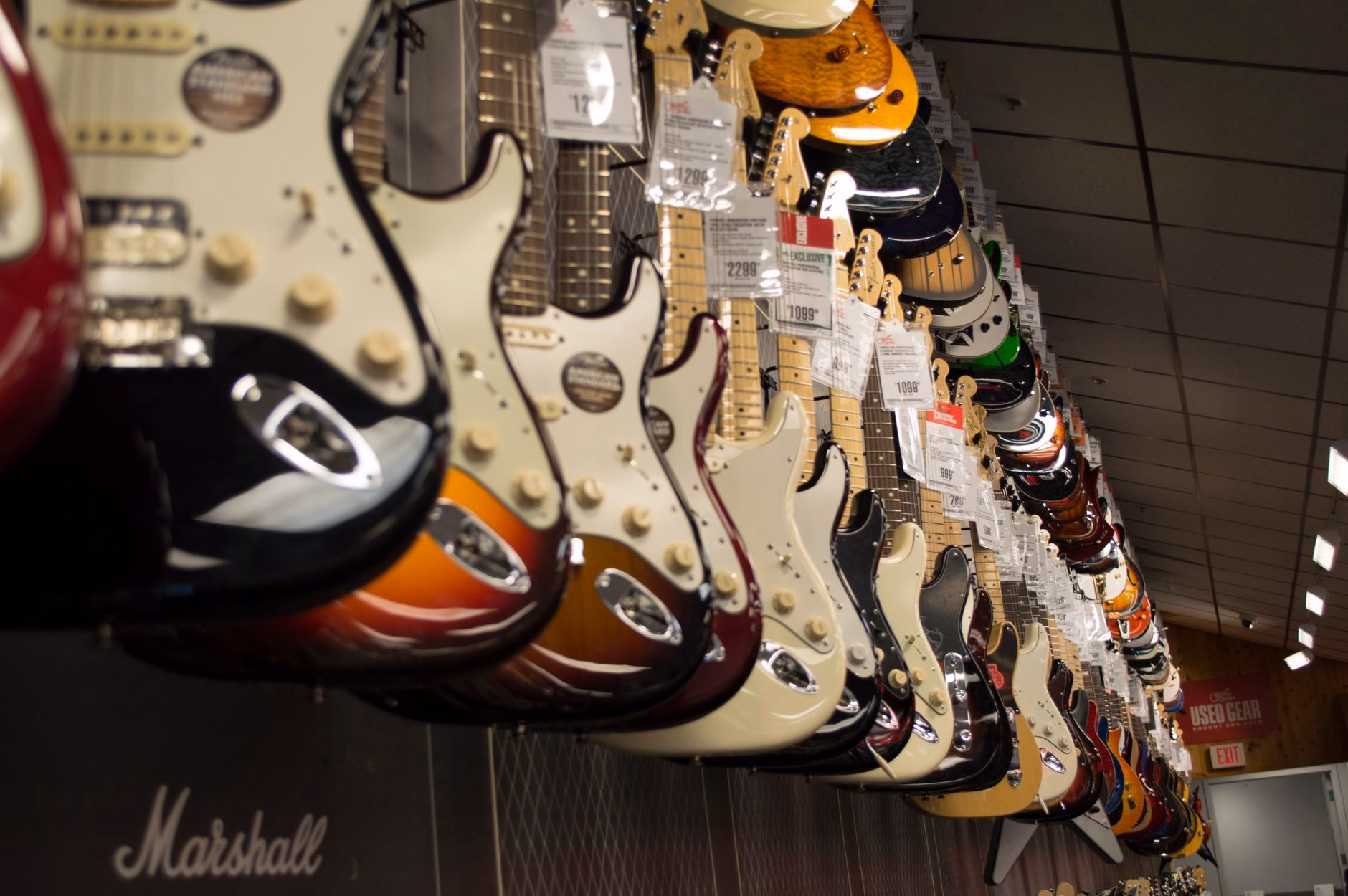electric guitar hanging near wall